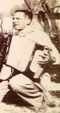 George R Gomez playing the accordion in the back yard at home on Kentucky St.,   Anadarko, OK